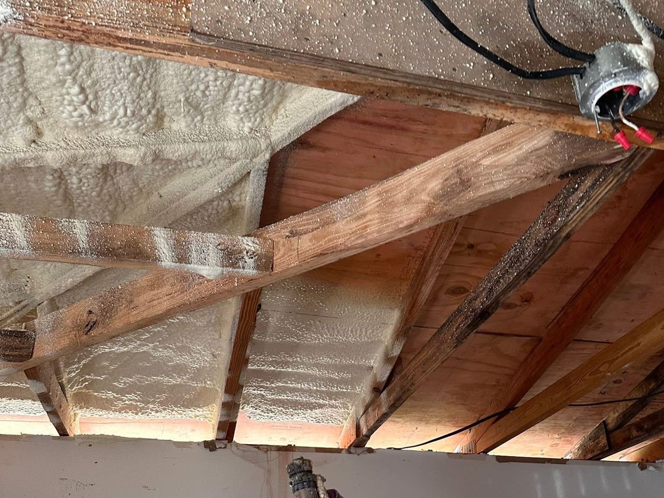 Foam applied between rafters at the roof deck