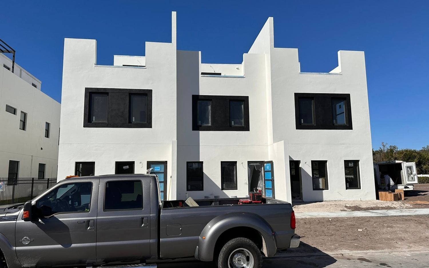 Finished townhouse elevation with black window frames