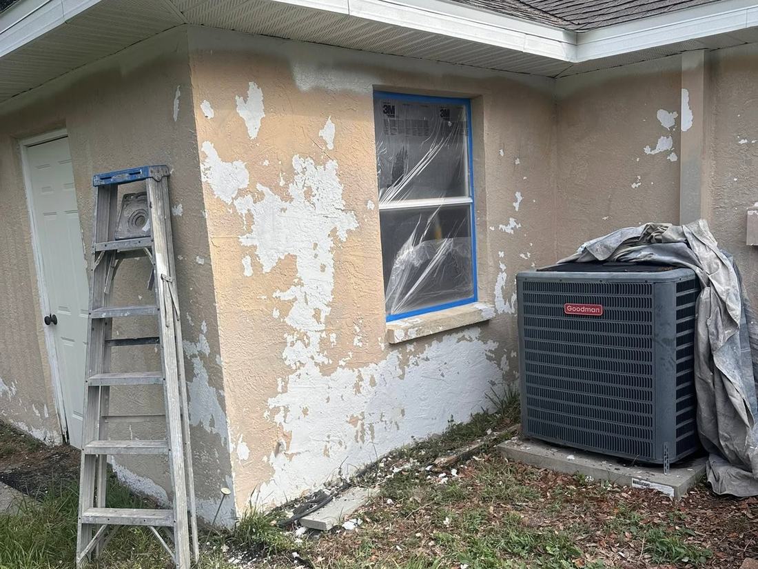 Stucco wall with paint peeling away in sheets