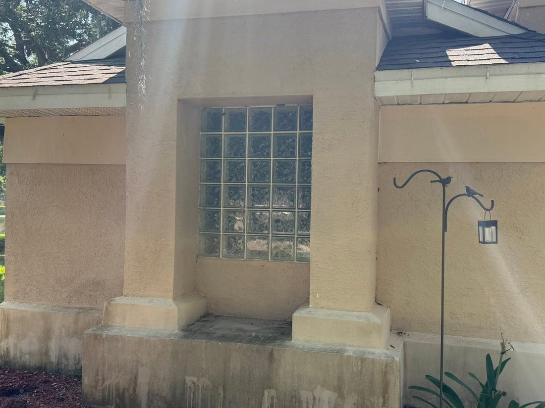 Stucco columns heavily stained and weathered